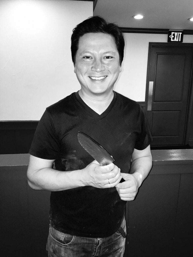 Kenji holding a KAN knife in his old restaurant
